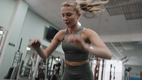 woman exercising jumps on floor in the gym.