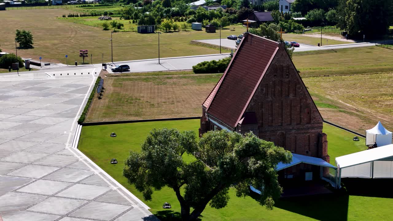 Green meadow and beautiful church, aerial orbit view