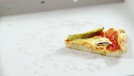 slice of pizza in pizza box