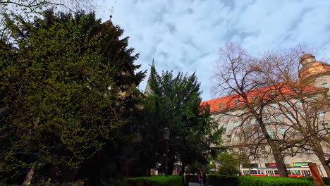 moving through a garden with a view on one of the old buildings in the city of prague