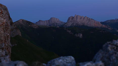 blue hour view of sheer granite exposed ridgeline cliffs with rocky foreground