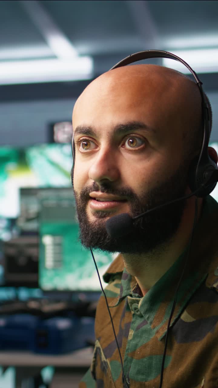 Vertical video Radio communications operator discussing with colleague using headset mic