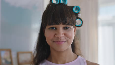 portrait funny teenage girl wearing hair curlers smiling happy teenager at home teen self image concept 4k footage