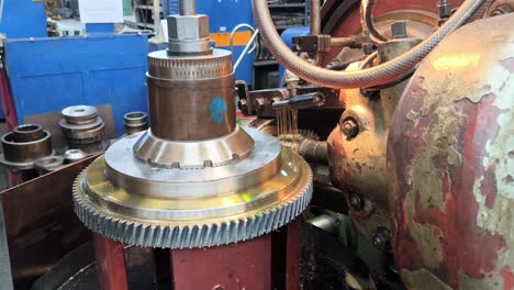 vintage gear production machine tool in an industrial setting, used for mechanical gear manufacturing, metal brush spinning