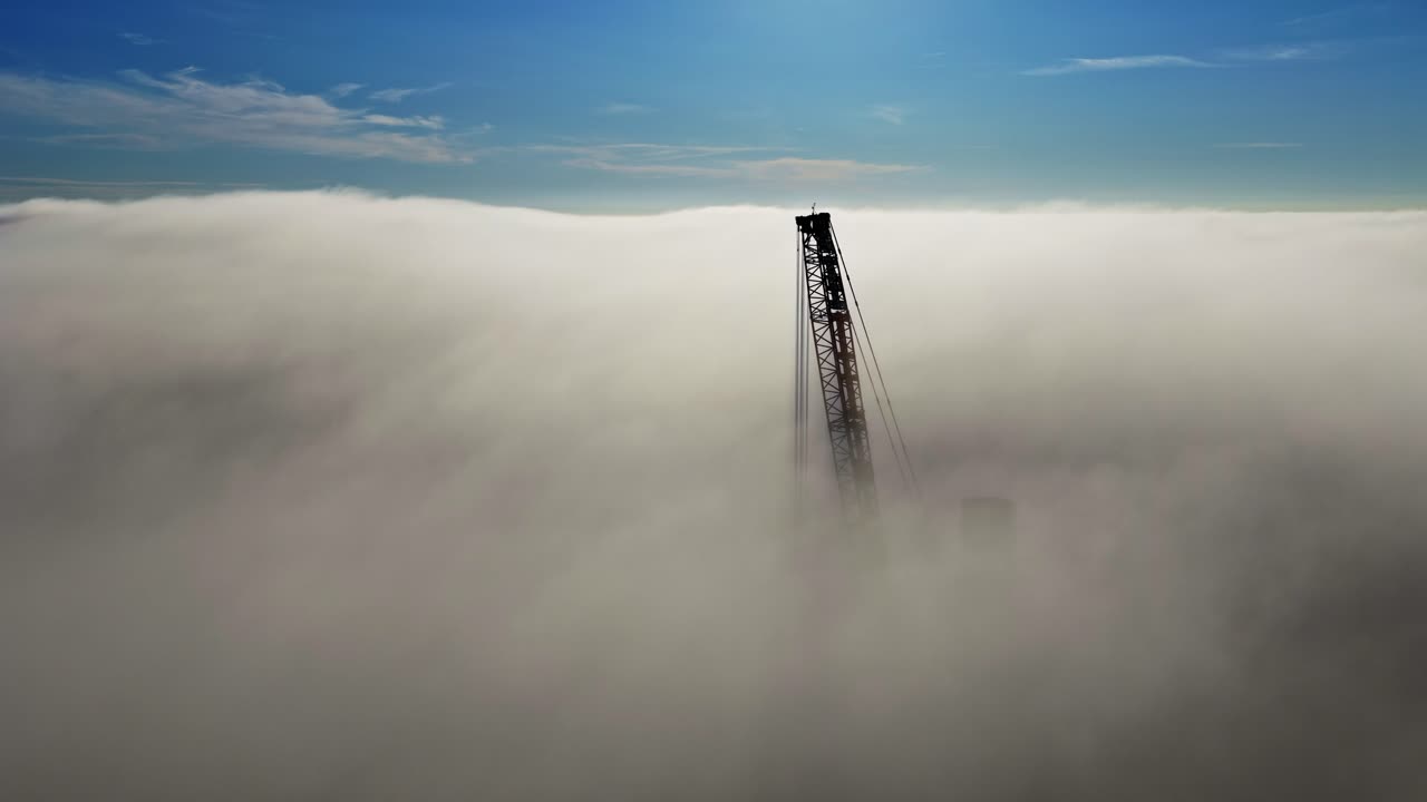 A tower emerges through morning fog, portraying mystery and solitude