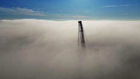 a tower emerges through morning fog, portraying mystery and solitude
