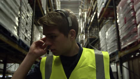 man locating stock in a storage warehouse, shot on r3d