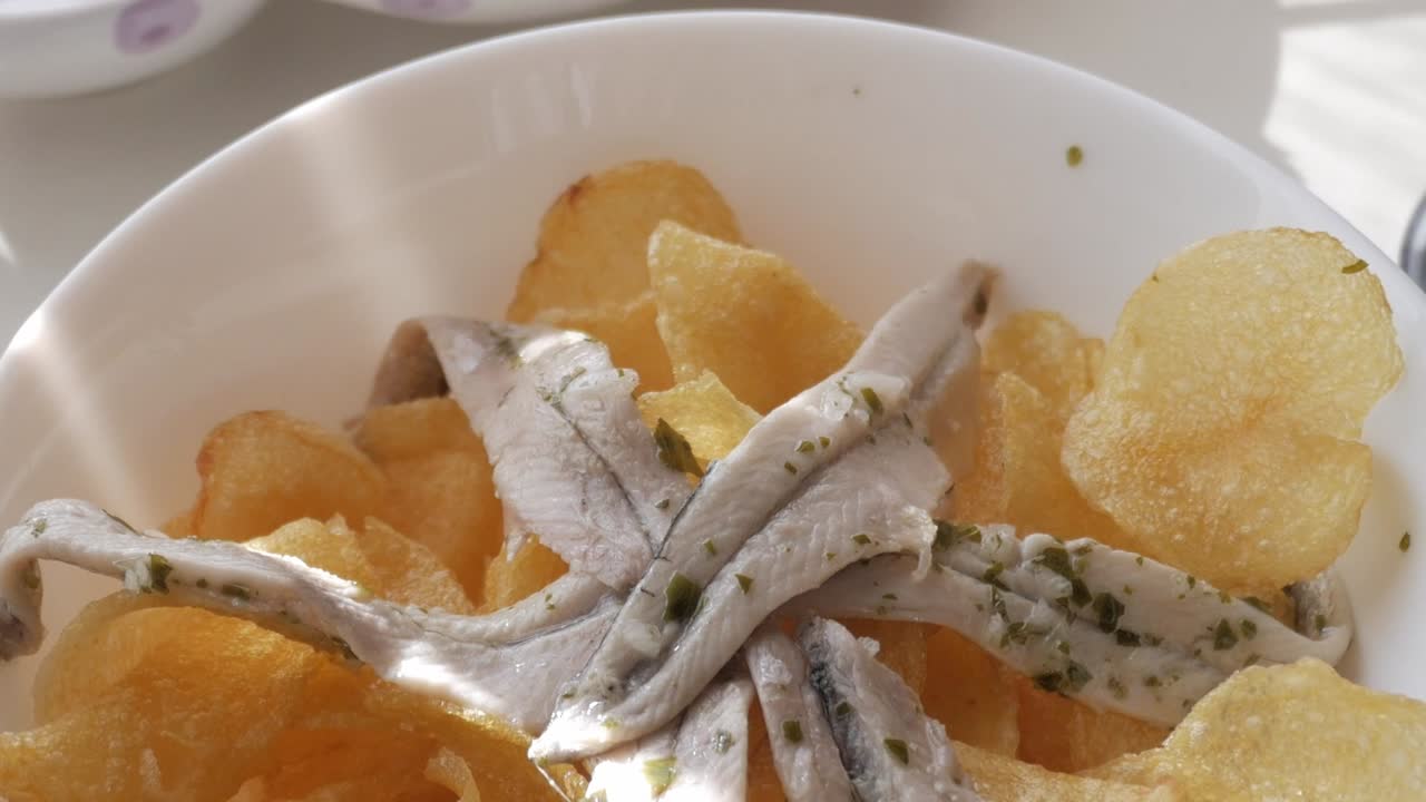 Fresh tapas of potato chips topped with boquerones, a Spanish appetizer