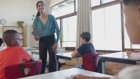 engaging with students, teacher in school classroom fostering interactive learning