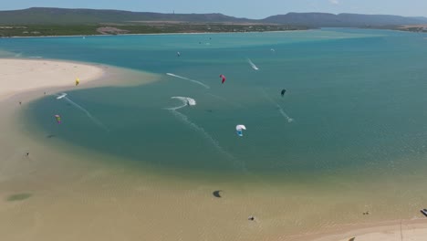 kitesurfer rides the breeze on breede river near witsand, south africa’s wild coastline