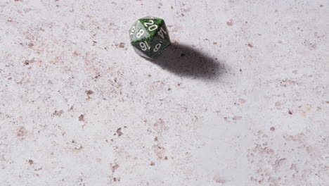 D20-20-sided-dice-rolling-on-white-marble-table,-close-up