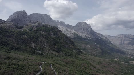 Drone-video-of-frontal-plane-on-the-Sh21-road-in-albania,-on-the-way-to-the-Theth-valley,-towards-Mount-Korab,-road-without-traffic-can-be-seen