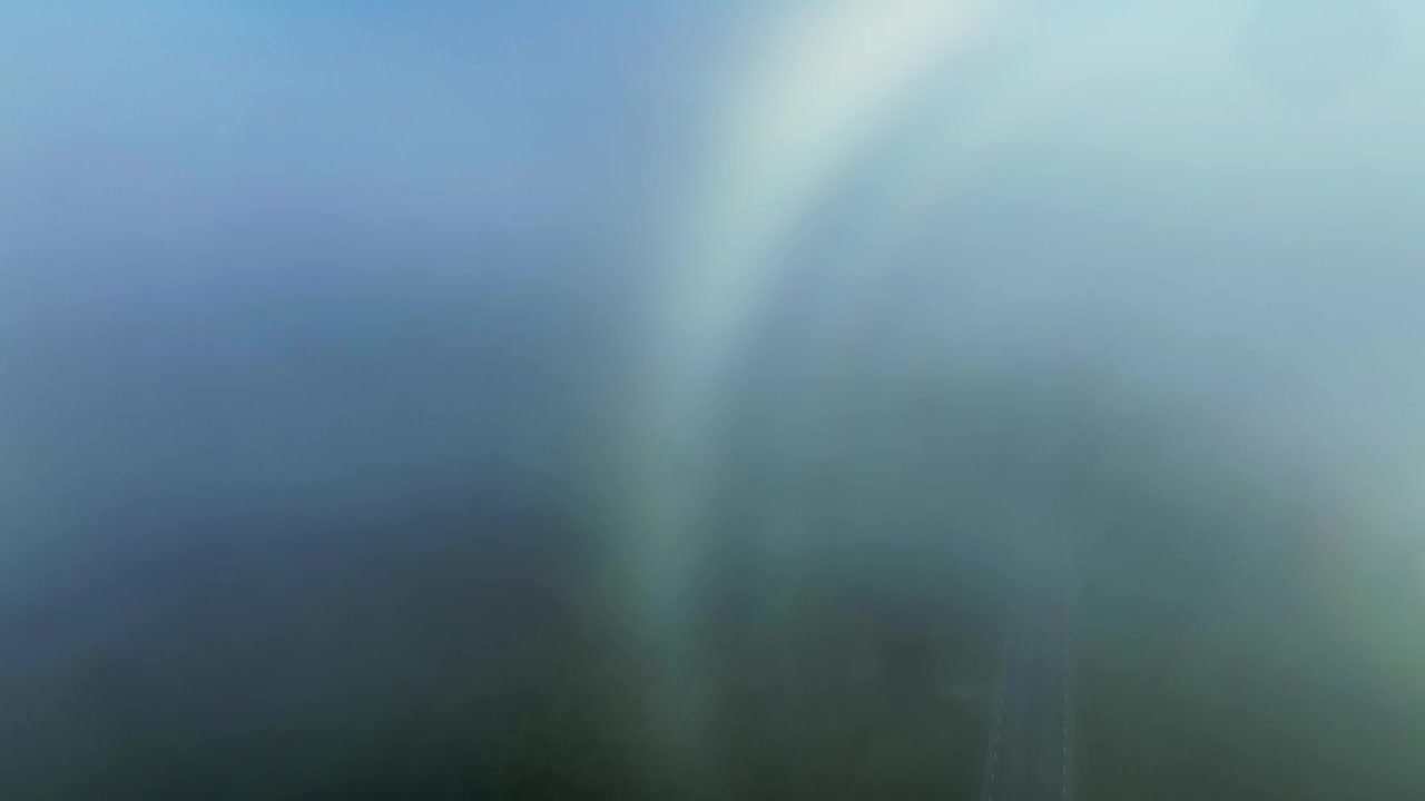 Drone follows the white fog bow from the surface of fog til the ground. Saaremaa, Estonia.