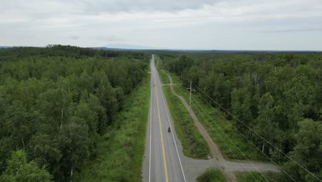 bikepacking through wilderness. droneshot. empty street