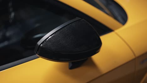 expanding carbon fiber side mirror on luxury yellow car