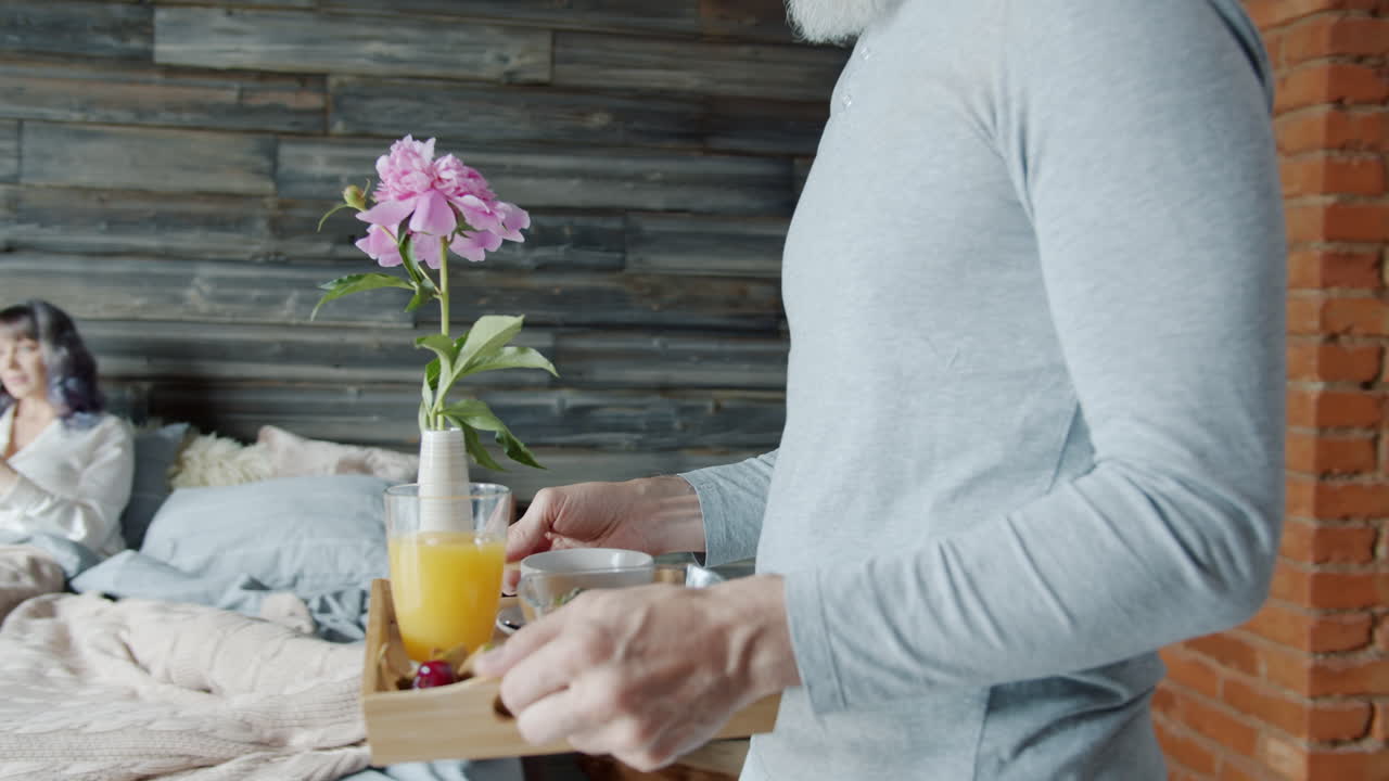 Couple in bedroom with a flower