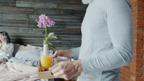 couple in bedroom with a flower