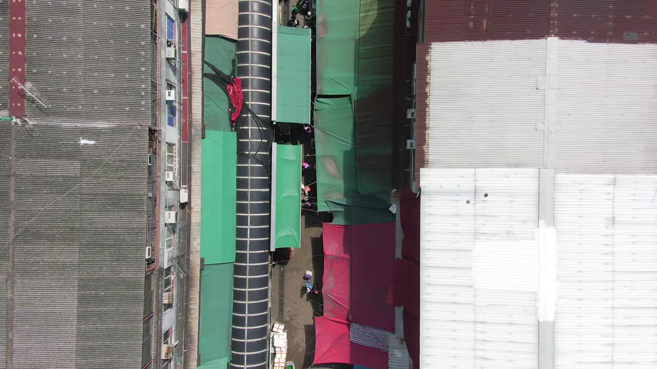 Ngau Chi Wan wet market rooftops, downtown Hong Kong with fresh Meat and Fish stalls, Top down aerial pass