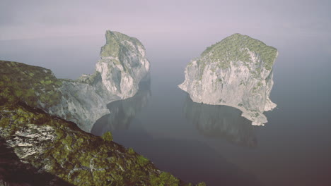 majestic rocky formations rise from tranquil waters at dawns first light