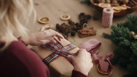 blonde woman packing christmas present