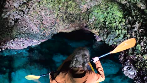 woman in kayak, blue cave on cres island