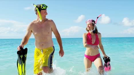 caucasian couple at vacation beach resort with snorkels