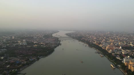 stunning aerial view of the iconic howrah bridge over the serene waters of the hooghly river in kolkata.