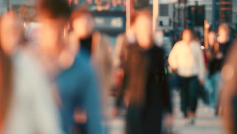 a crowd of people walking through the city