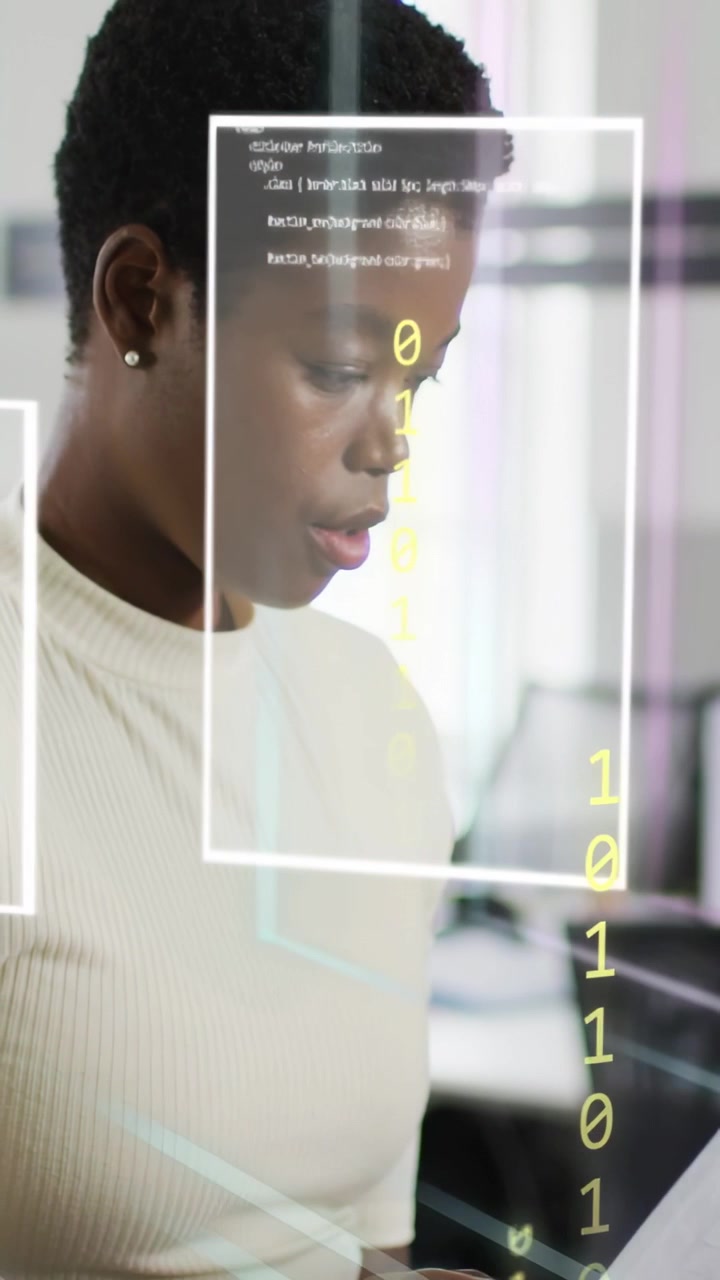 Vertical video: Woman holding document in tech office, causing AR UI and code overlays for analysis