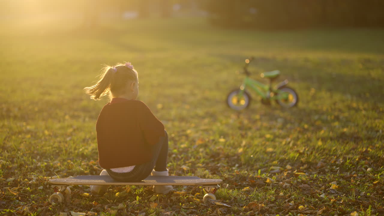 Girl skateboarding in the park at sunset