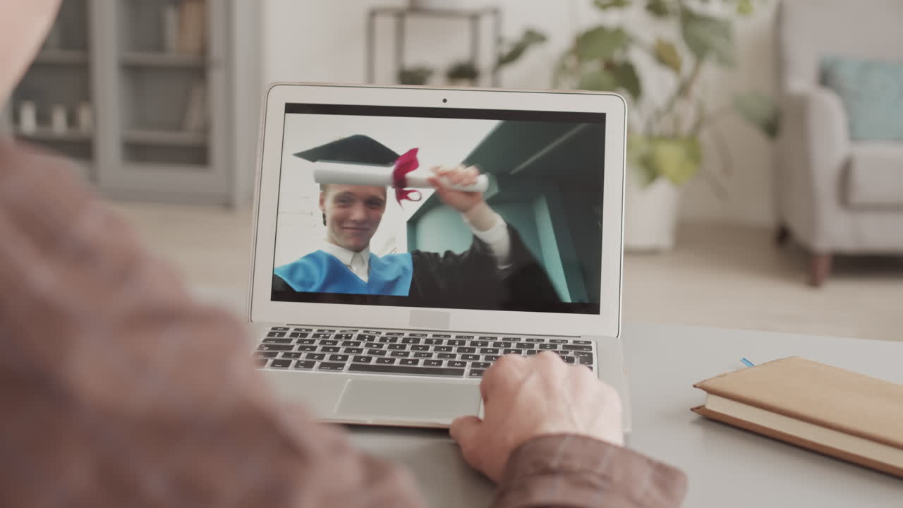 Parent Having Video Call with Son during Graduation Ceremony