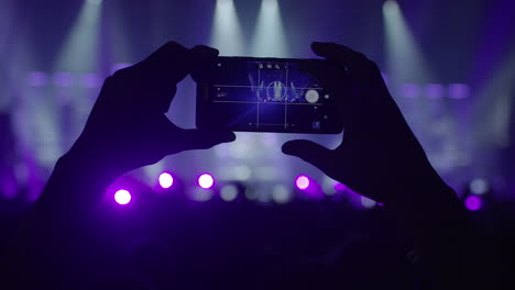 making photos with a smartphone on a live concert