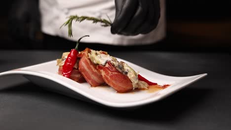 chef preparing a delicious bacon-wrapped dish