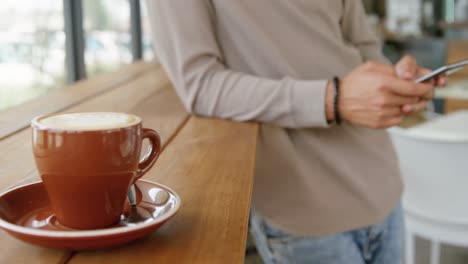 man using mobile phone in coffee shop 4k