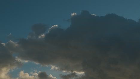 timelapse of moving clouds against a blue sunny sky, low angle static