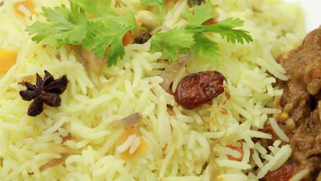 chicken biryani showing leg piece - it's a delicious recipe of basmati rice mixed with with spicy marinated chicken in a bowl. served in a bowl or plate. selective focus