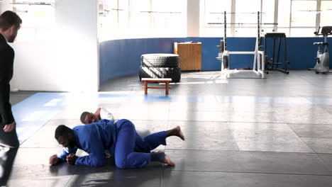 practicing judo, two men grappling on mat in training session