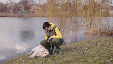 man and dog by the lake