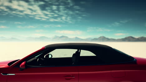 red convertible car in a desert landscape