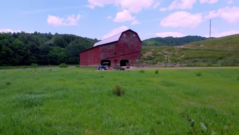 fast aerial pullout of large red barn in sugar grove nc near boone nc, north carolina