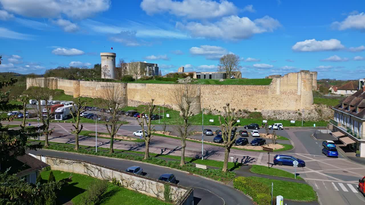 Imposing stone walls and entrance to historic Château de Falaise, William the Conqueror's castle, Normandy, France. Aerial drone forward at low altitude