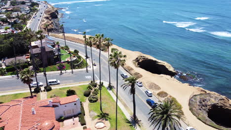 road intersection at tropical region with rocky coast and ocean, aerial view