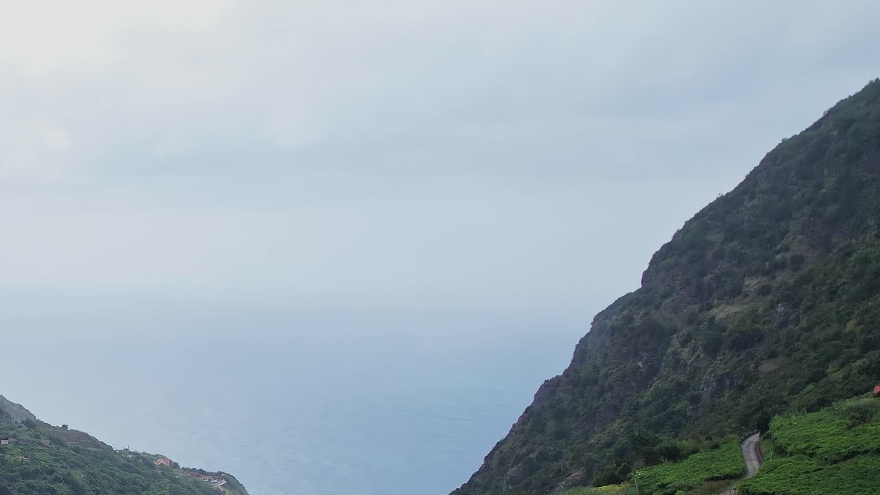 Drone view of coastal hills and vineyards overlooking the ocean in Madeira