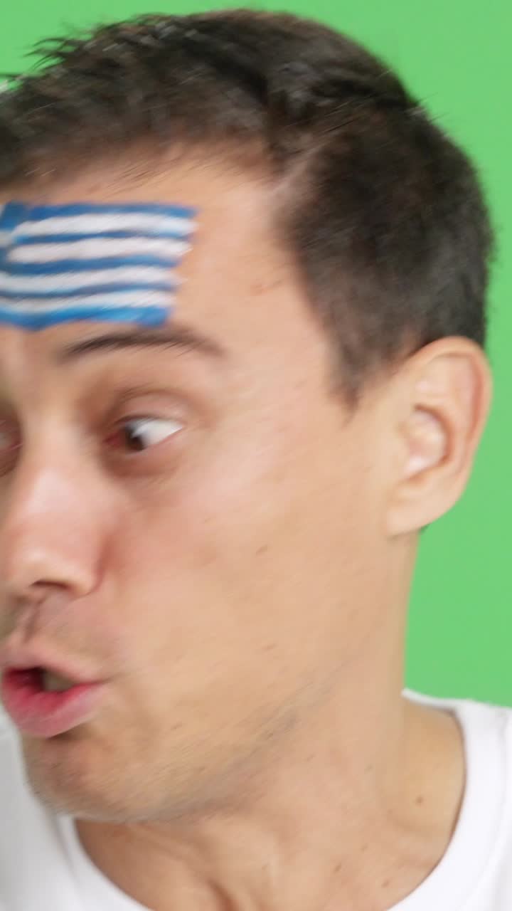 Close up of a man supporting greek team