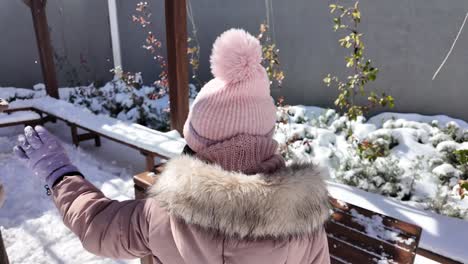 child playing in the snow