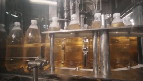 conveyor belt with bottles for juice or water at a modern beverage plant. modern production of sweet soda water