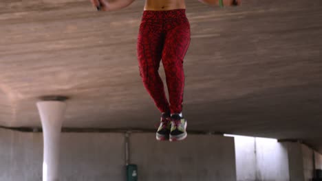 front view of young african american woman exercising with skipping rope in the city 4k