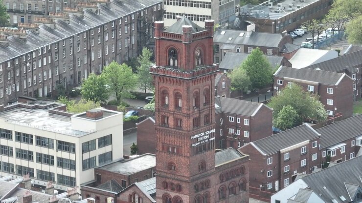 A red brick church tower and surrounding buildings near Hamilton Square in Birkenhead England United Kingdom