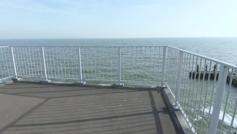 descend the stairs to the observation deck overlooking the sea