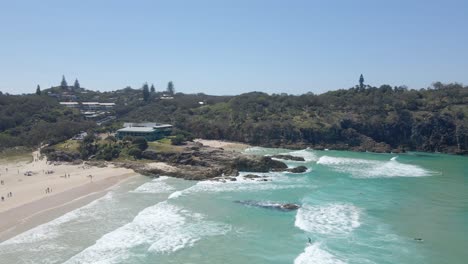 Aerial-View-Of-The-Ocean-Waves-At-The-Main-Beach-With-A-View-Of-The-Headland-Reserve-In-QLD,-Australia